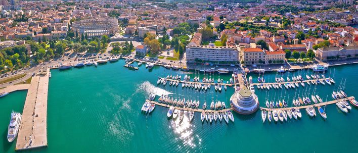 Luftaufnahme von Pula in Kroatien mit Blick auf den Hafen, zahlreiche Segelboote und die historische Altstadt