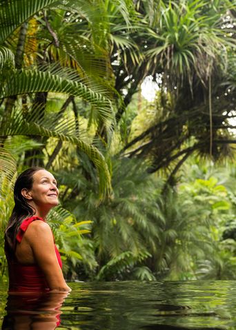 Frau in einem roten Badeanzug in einem Pool im Regenwald von Costa Rica