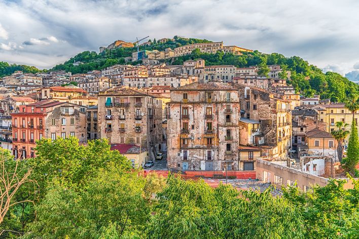 Panorama von Cosenza mit historischen Gebäuden vor grünen Hügeln