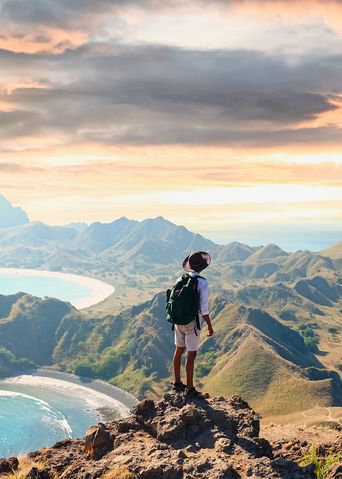 Mann mit Rucksack blickt im Komodo-Nationalpark auf der Insel Padar in Indonesien