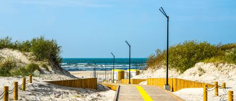 Blick über einen Holzsteg auf den Strand von Liepāja in Lettland