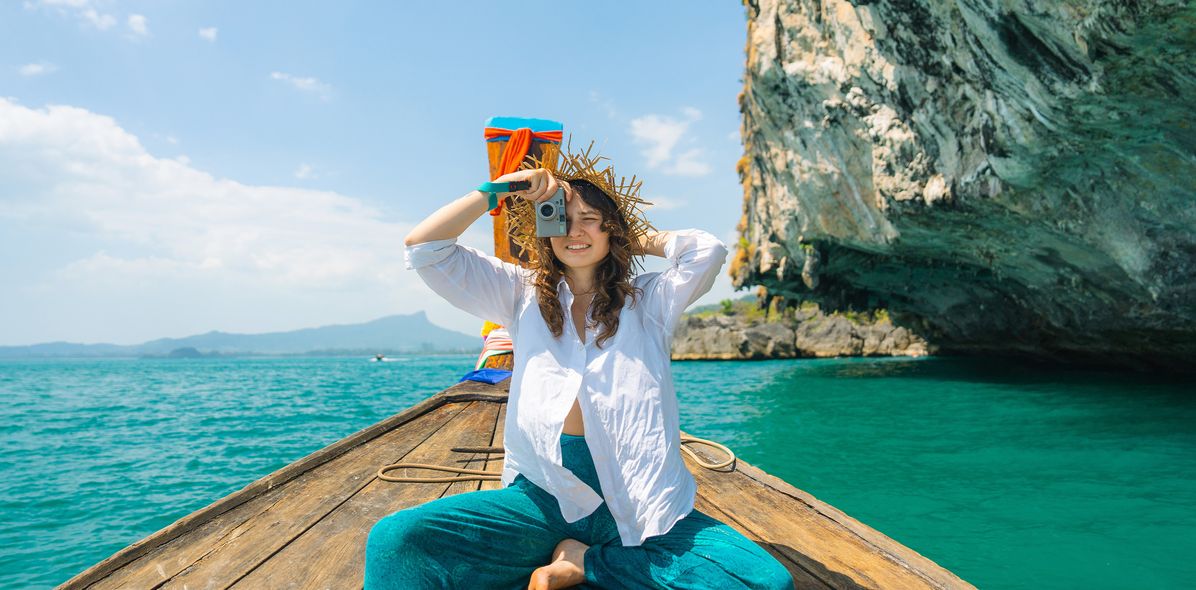 Frau im Longtailboot und fotografiert 