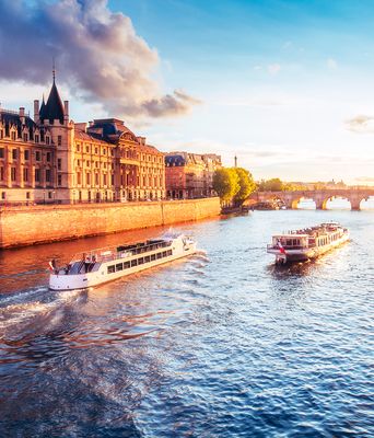 Bootsfahrt auf der Seine in Paris bei Sonnenuntergang mit historischen Gebäuden