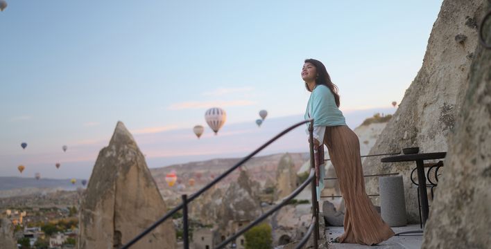 Frau genießt die Aussicht auf die Felslandschaft Kappadokiens bei Sonnenaufgang