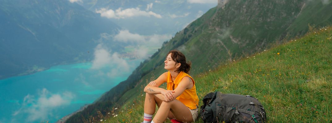 Frau genießt eine Wanderpause in den Schweizer Alpen