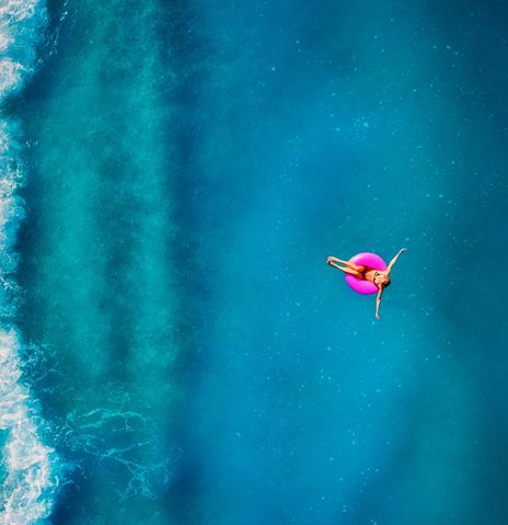 Frau auf Schwimmring im Meer