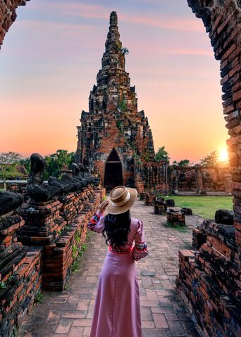 Eine Frau wandert durch die Tempelanlagen von Ayutthaya