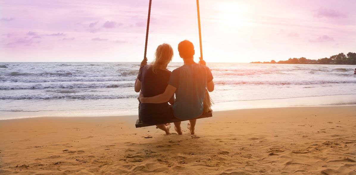 Paar auf einer Schaukel am Strand