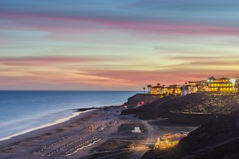 Playa de Esquinzo auf Fuerteventura bei Sonnenuntergang mit Atlantikküste und Hotels auf Jandía