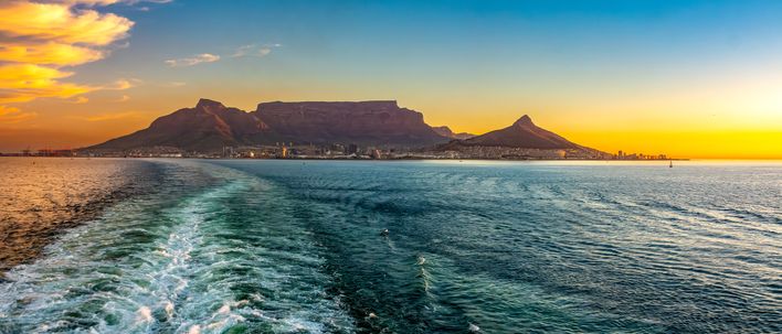 Blick vom Schiff auf Kapstadt mit Tafelberg bei Sonnenuntergang