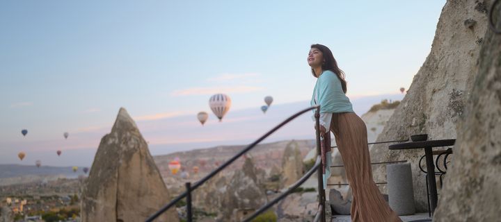 Frau genießt die Aussicht auf die Felslandschaft Kappadokiens bei Sonnenaufgang