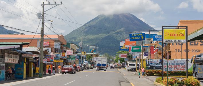 Straßenszene in La Fortuna in Costa Rica mit Blick auf den Vulkan Arenal im Hintergrund