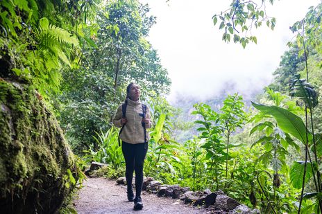 Eine Frau läuft durch den Regenwald in Peru