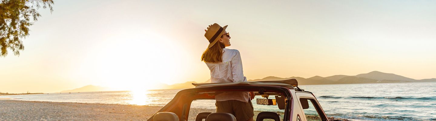 Frau im Auto am Meer