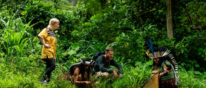 Reisende erkunden den grünen Regenwald Brasiliens auf einem schmalen Pfad zwischen dichtem Blattwerk und hohen Bäumen