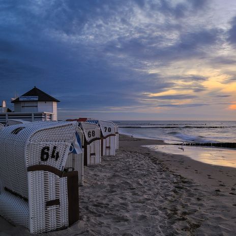 Strand mit Strandkörben und Sonnenuntergang