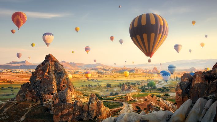 Panoramablick über die Felsenlandschaften in Kappadokien voller Heißluftballons