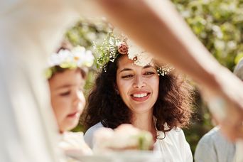 Menschen mit Blumenkränzen feiern Midsommer in Schweden