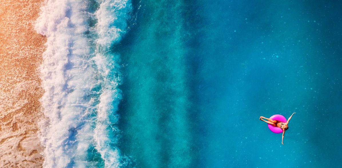 Frau im Schwimmreifen auf dem Meer