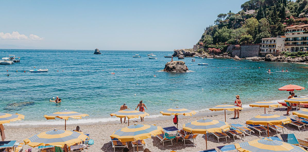 Strand auf Sizilien mit Sonnenschirmen und Badegästen