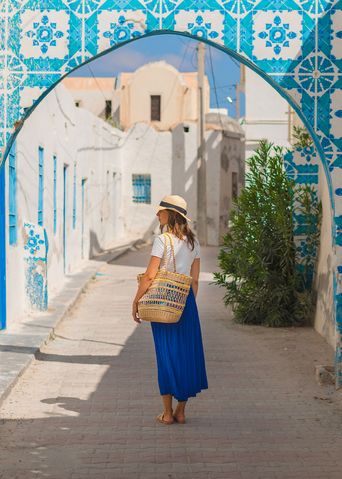Eine Frau spaziert durch die Gassen des Houmt Souk in Djerba, Tunesien