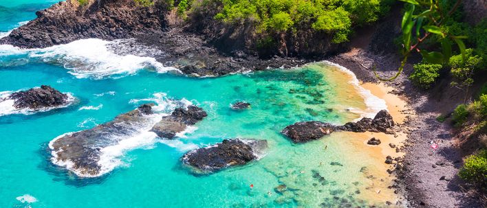 Türkisblaues Meer und kleine Inseln vor Fernando de Noronha aus der Luft