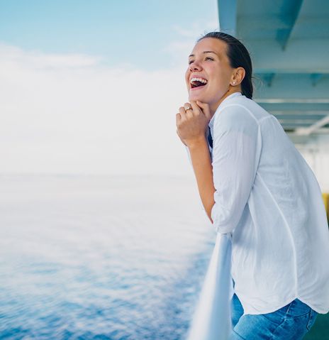 Fröhliche Frau auf Kreuzfahrtschiff